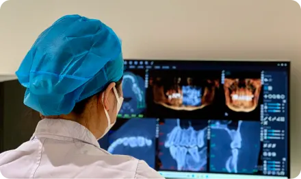A dental professional reviewing digital dental scans