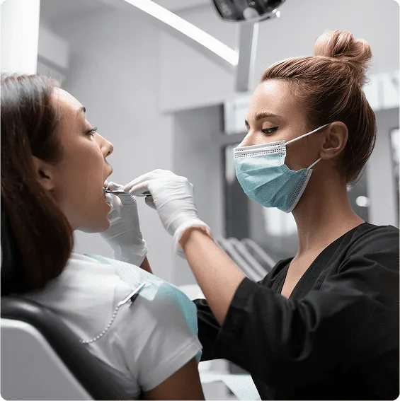 A dental professional examining a patient